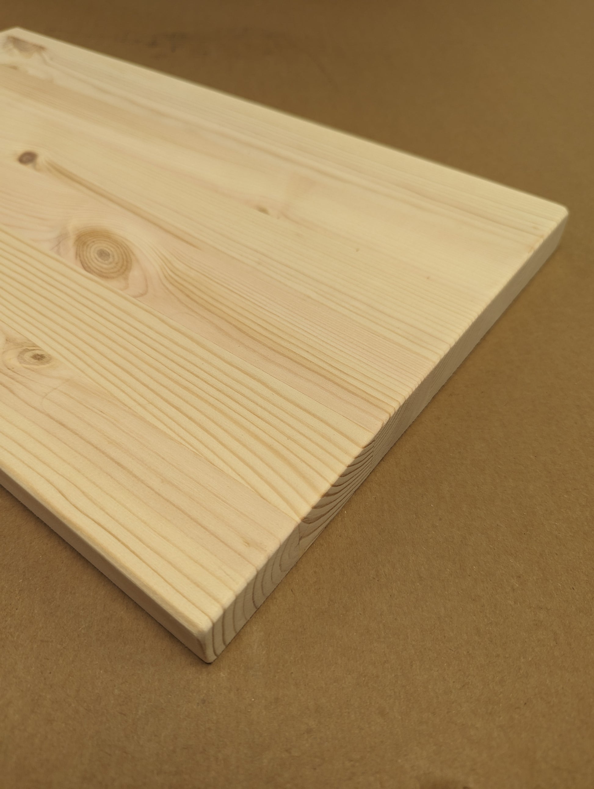 Plain wooden board on a brown background
