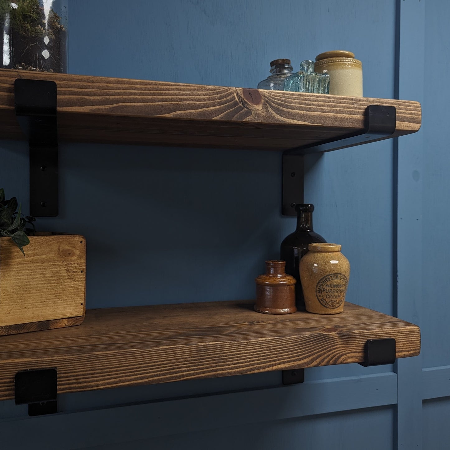 Dark Oak 30mm Wooden shelves with decorative jars against a blue wall