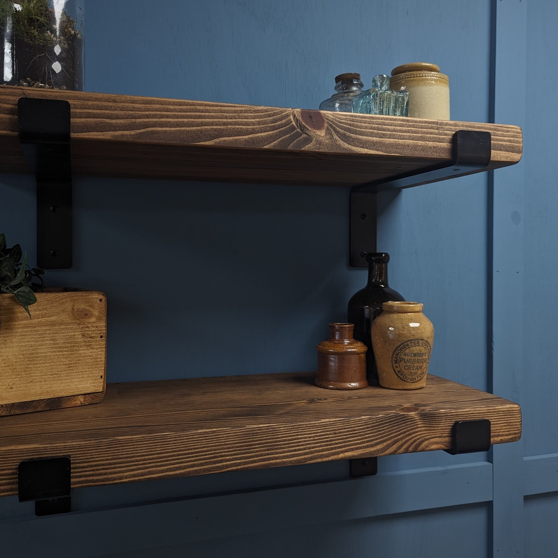 Dark Oak 30mm Wooden shelves with decorative jars against a blue wall