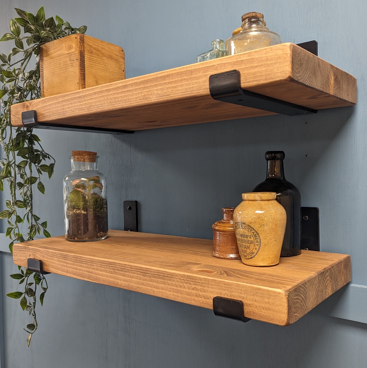 40mm Wooden shelves with decorative items against a gray wall